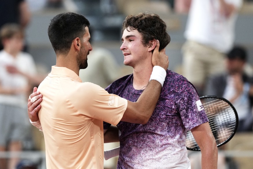 Winner Brazil's Joao Fonseca (R) greets Serbia's Novak Djokovic
